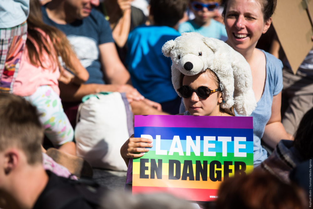 A girl with a white bear, at the march in Paris.